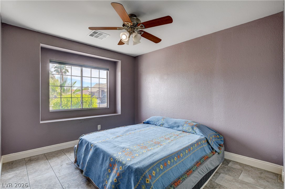 910 Cobblestone Cove Road North Las Vegas, NV 89081 - Photo 18 of 30 A quiet bedroom retreat with a window offering glimpses of lush foliage.