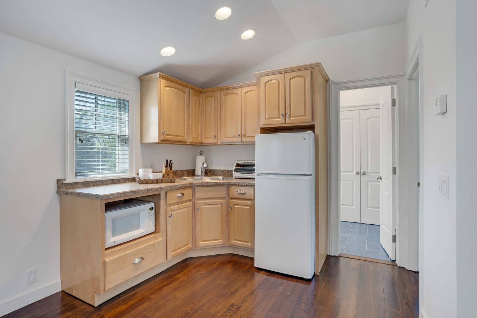 91 Osprey Way Water Mill, NY 11976 - Photo 27 of 46 a kitchen with a refrigerator sink and cabinets