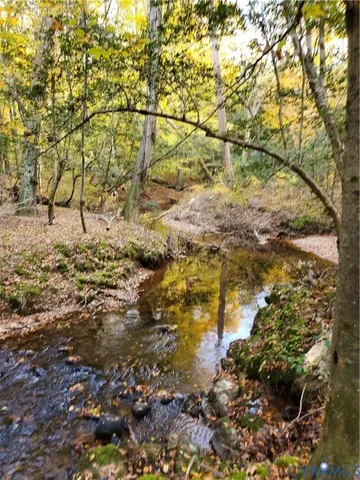 a backyard of a house with a yard and outdoor seating