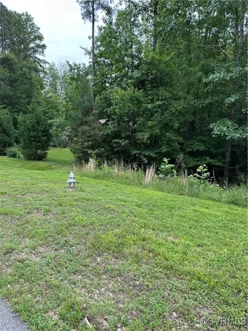a view of outdoor space with green field and trees