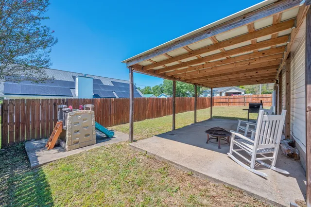 a view of a backyard with a patio
