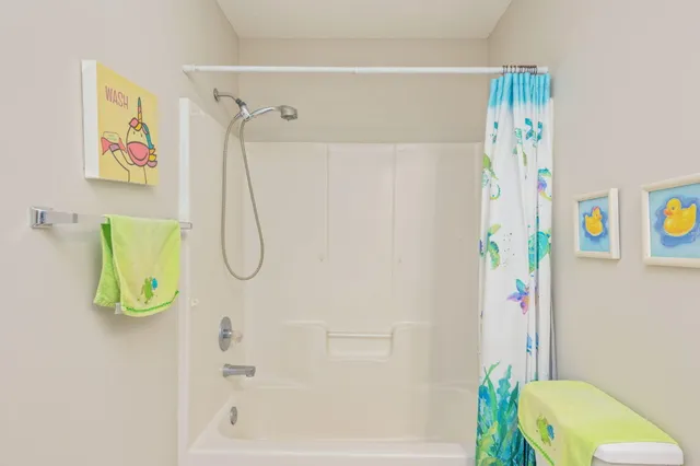 a bathroom with a shower and a bath tub