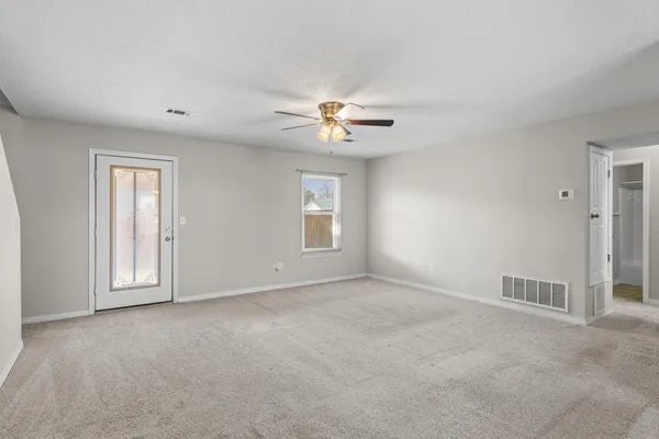 a view of a hallway with a ceiling fan