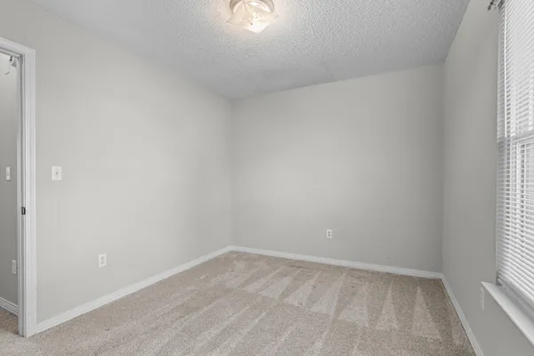 an empty room with fan and a ceiling fan