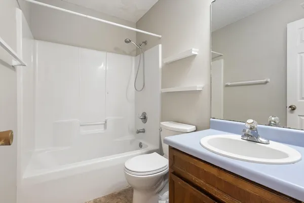 an empty room with ceiling fan and window