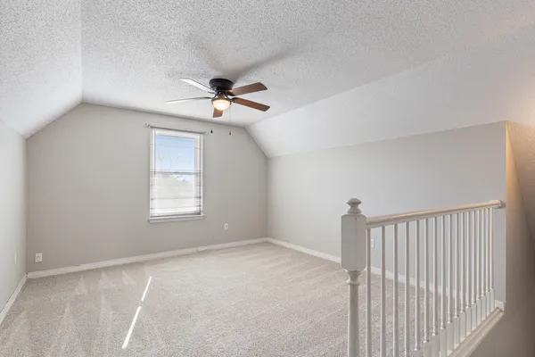 a view of backyard with wooden fence