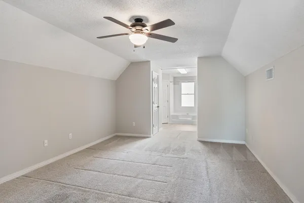 a view of a house with backyard and trees