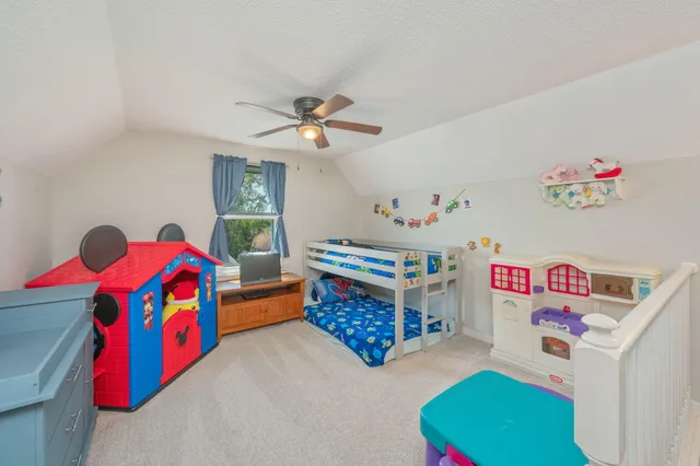 a bedroom with furniture and a book shelf