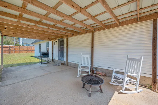 a view of a house with backyard and a tree