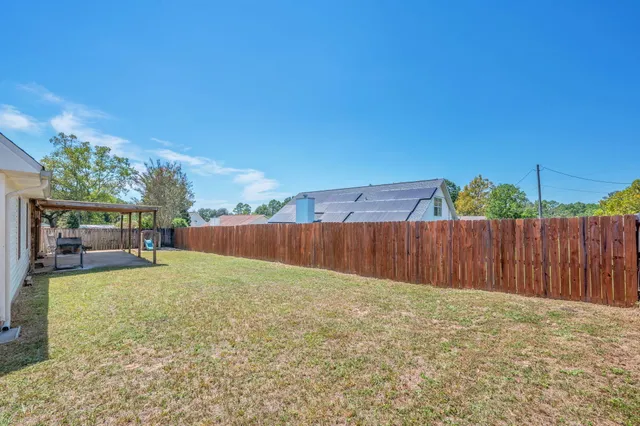 a backyard of a house with table and chairs