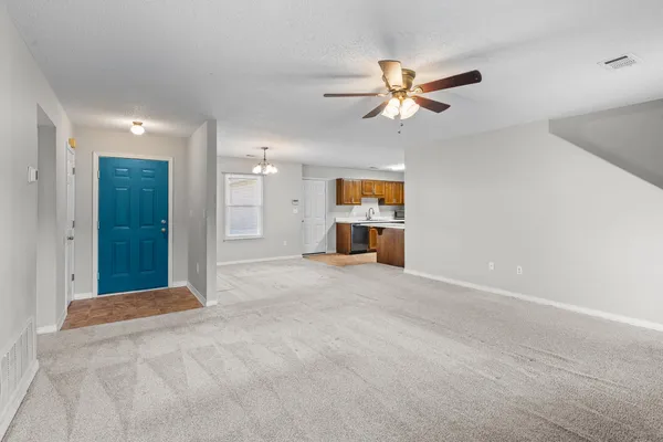 a kitchen with stainless steel appliances granite countertop a refrigerator stove and sink