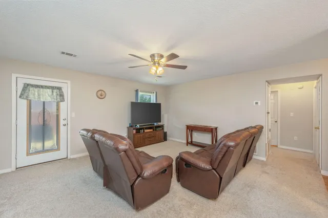 a view of a dining room with furniture and a chandelier