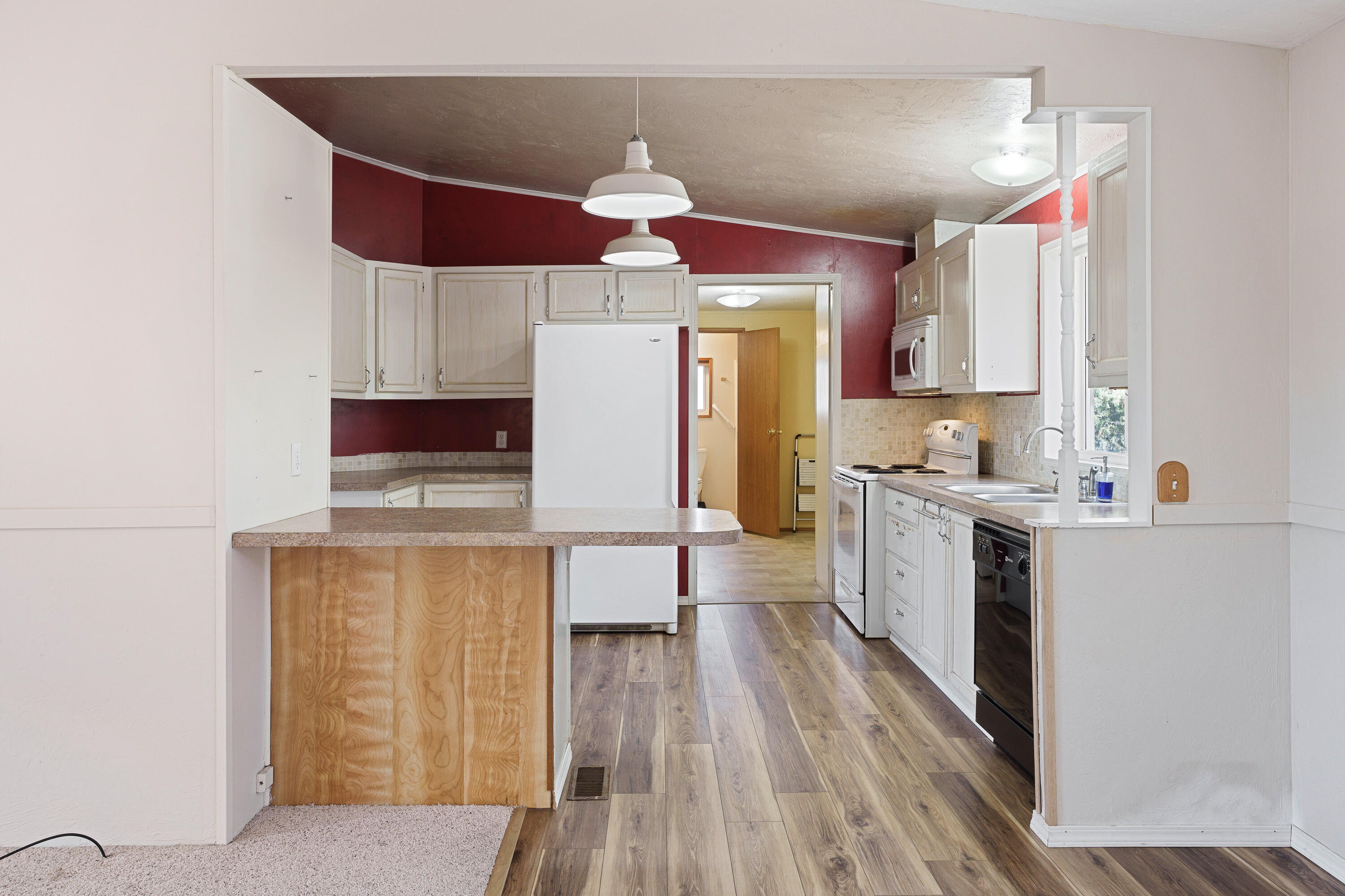 5674 Southeast Davis Loop Prineville, OR 97754 - Photo 10 of 48 a kitchen with a stove a refrigerator and a microwave