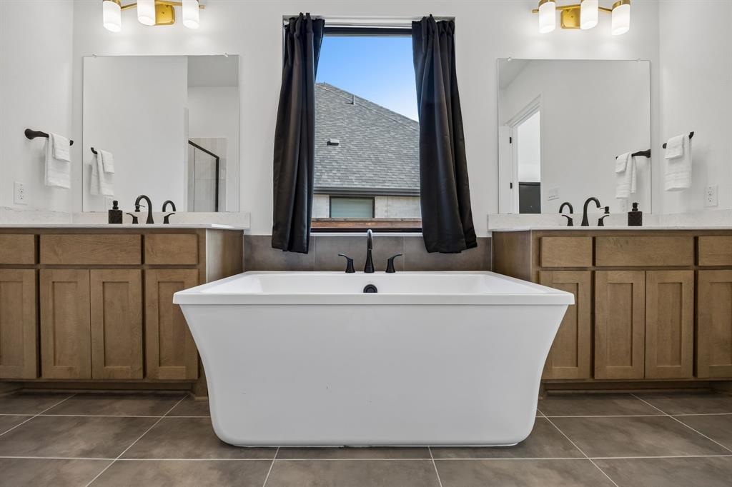 1717 Tolleson Drive Fort Worth, TX 76008 - Photo 14 of 40 a white bath tub sitting in a bathroom