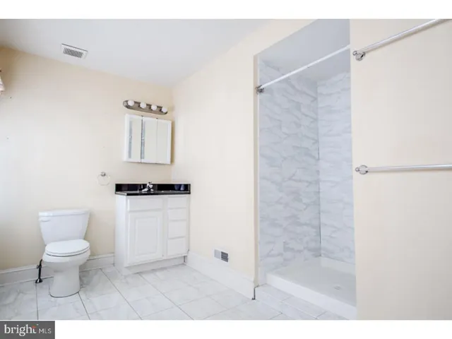 a bathroom with a toilet sink and a shower