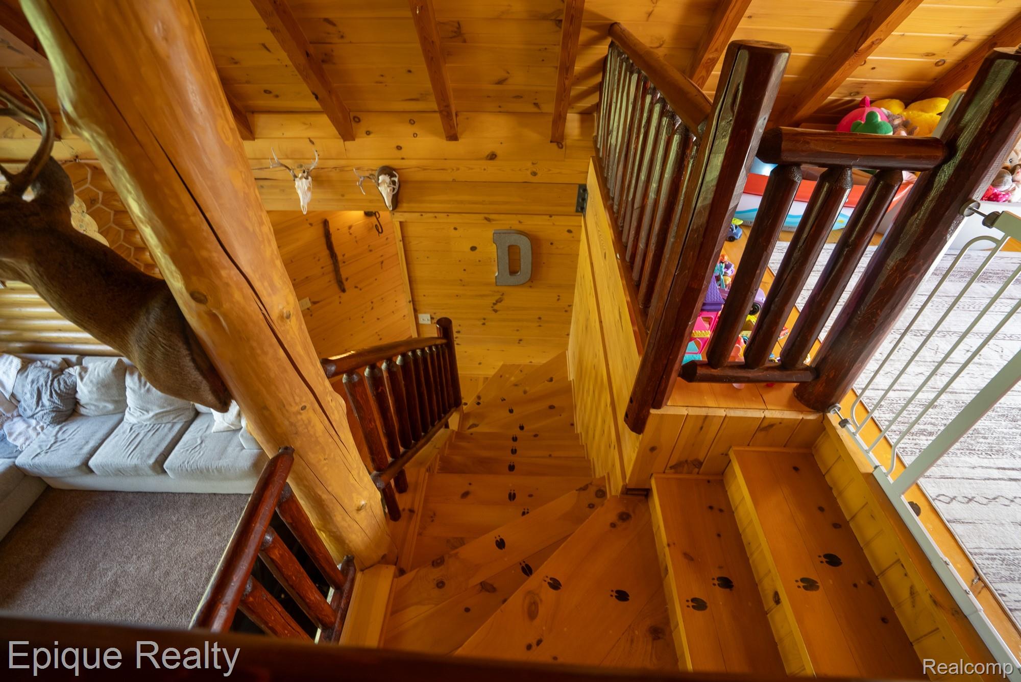 1966 Mayer Road Smiths Creek, MI 48074 - Photo 31 of 38 Natural wood staircase with log-style newel posts and railings