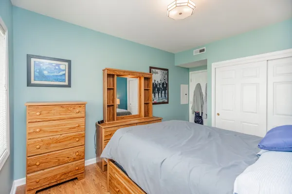 a bedroom with a bed and a dresser