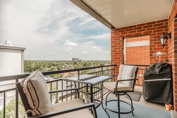 a view of a chairs and table in the balcony