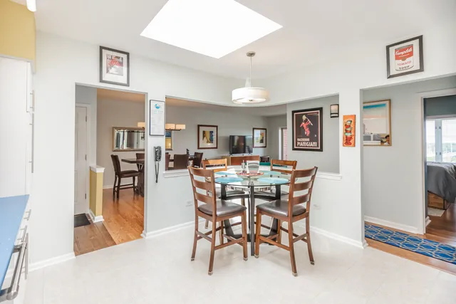 a view of a dining room and livingroom with furniture wooden floor and a rug