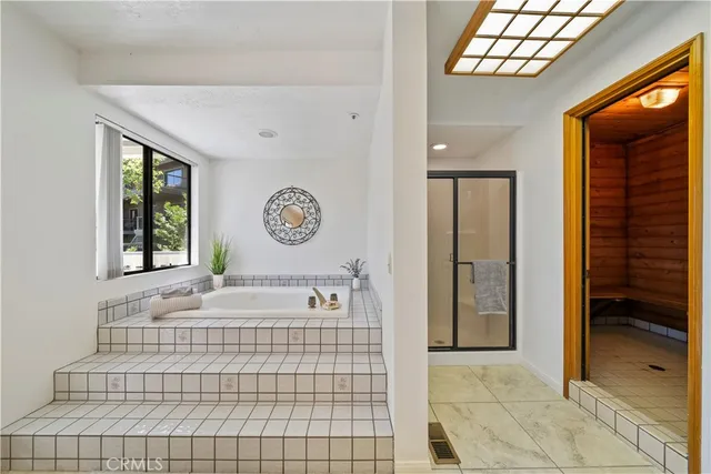 a large bathroom with a large tub and sink