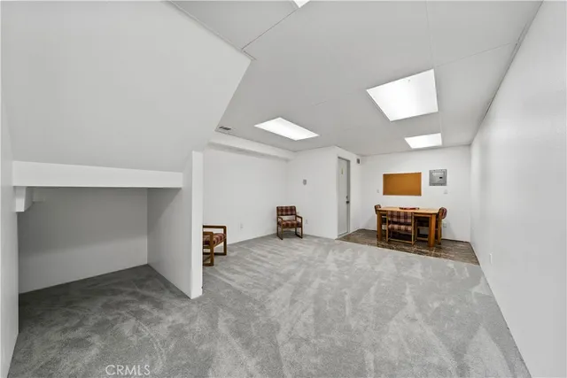 a view of a room with a furniture and a ceiling fan