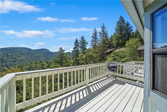a balcony with wooden floor and fence