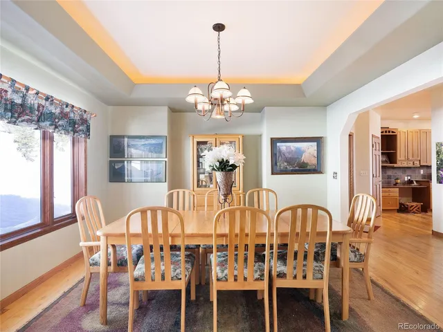 a view of a dining room with furniture wooden floor and chandelier