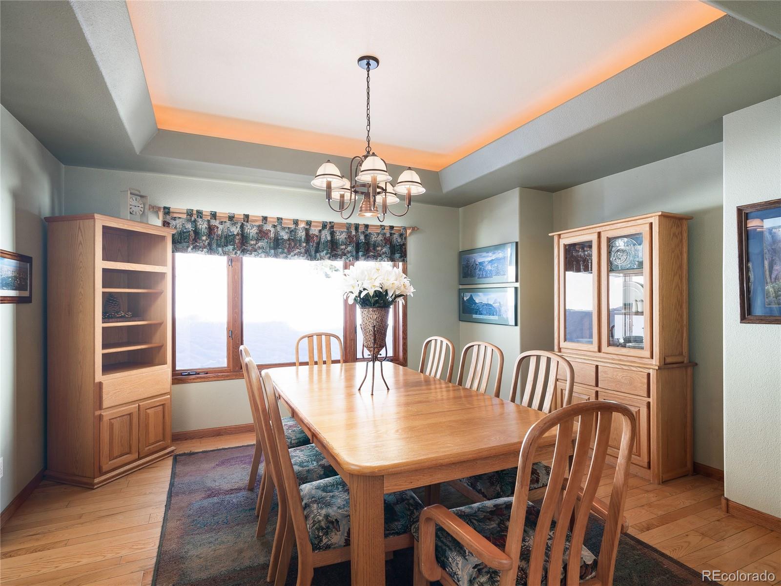 76 Raven Rdg Road Idaho Springs, CO 80452 - Photo 16 of 49 a view of a dining room with furniture window and wooden floor