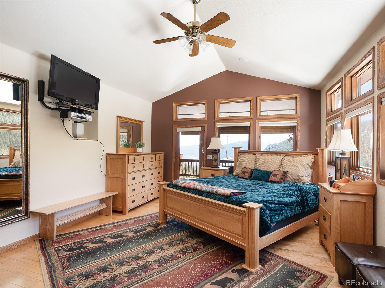 76 Raven Rdg Road Idaho Springs, CO 80452 - Photo 19 of 49 a bed room with furniture and a flat screen tv