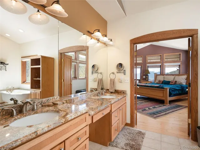 a bathroom with a granite countertop sink mirror and vanity
