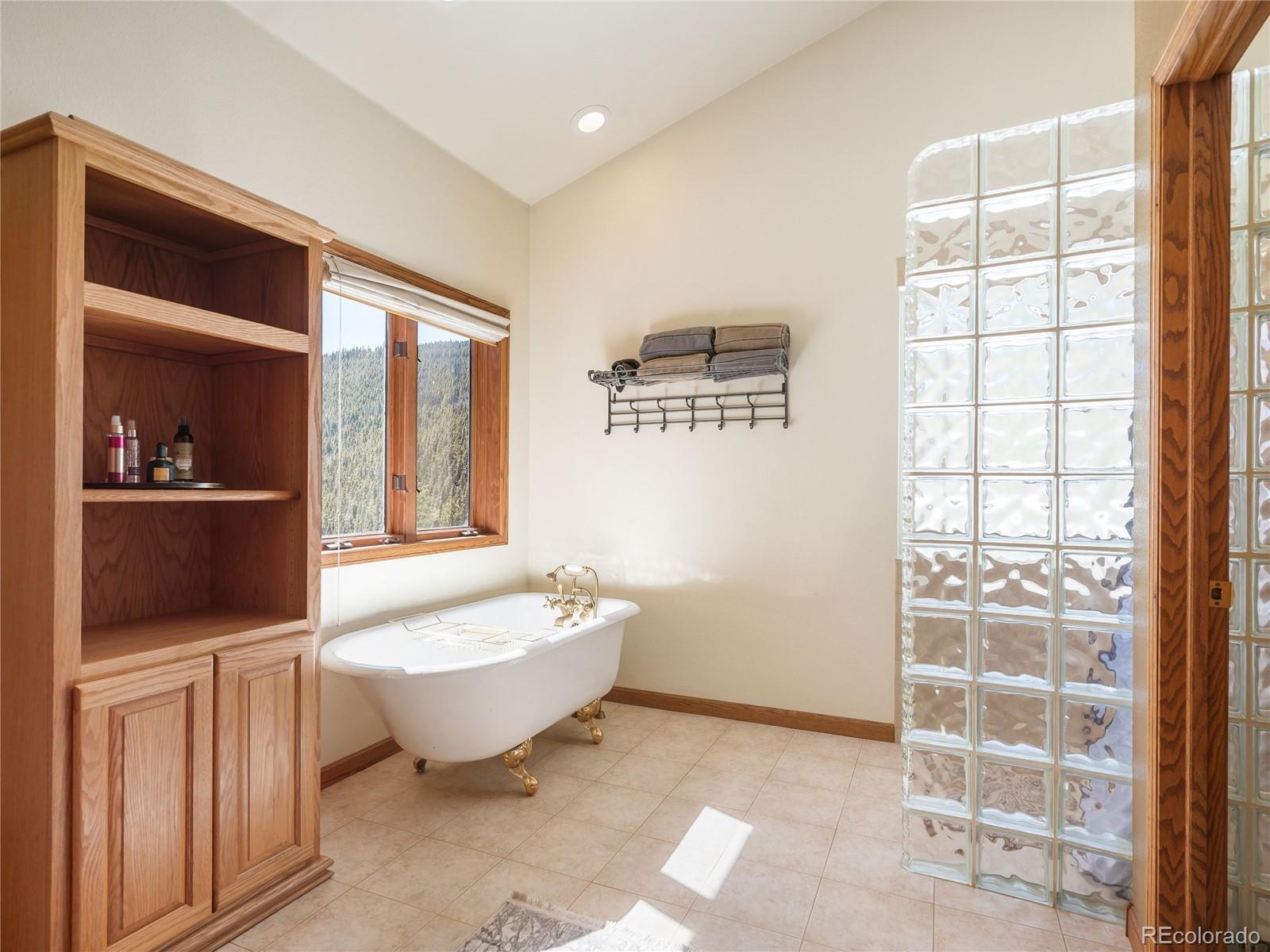 76 Raven Rdg Road Idaho Springs, CO 80452 - Photo 21 of 49 a spacious bathroom with a bathtub and sink