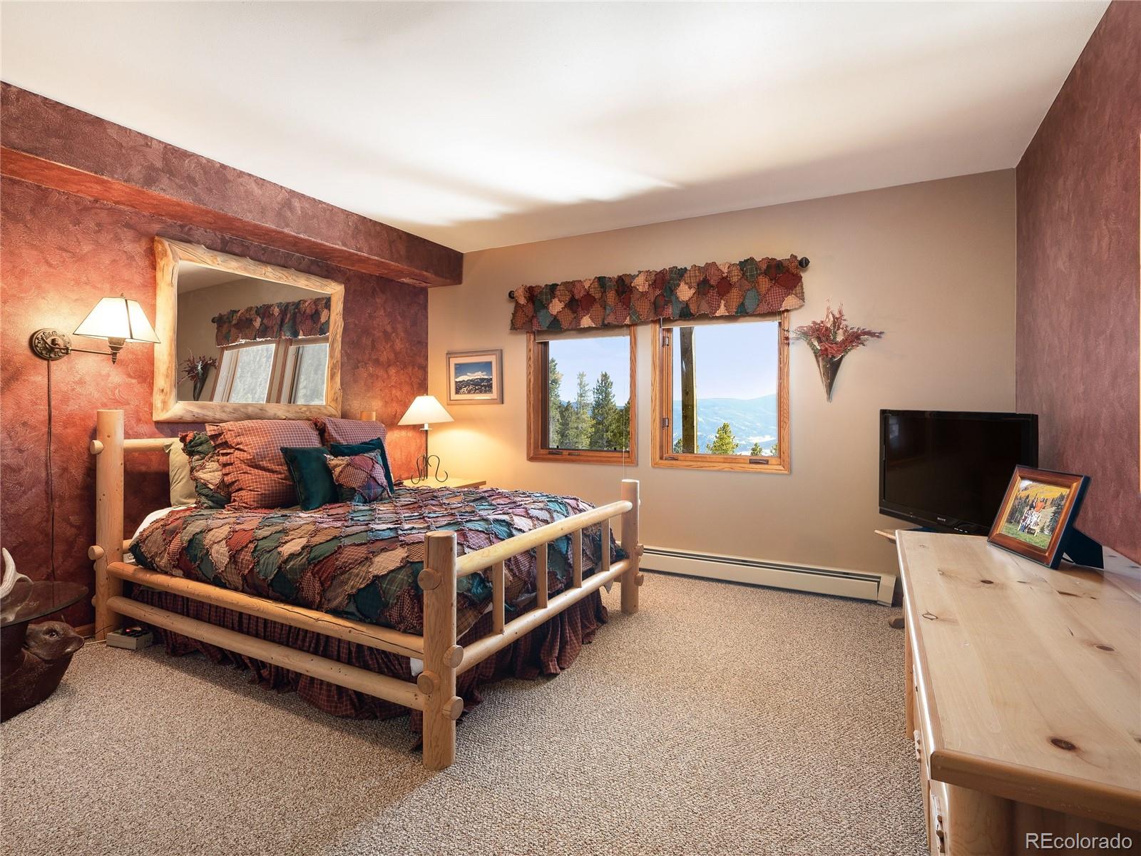 76 Raven Rdg Road Idaho Springs, CO 80452 - Photo 27 of 49 a bedroom with a bed and wooden floor