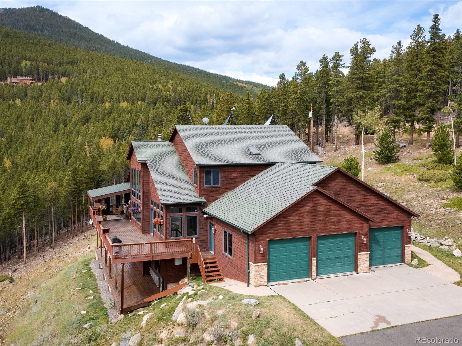 76 Raven Rdg Road Idaho Springs, CO 80452 - Photo 39 of 49 a aerial view of a house with a yard balcony and mountain view
