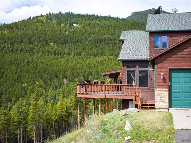 a aerial view of a house with pool and deck