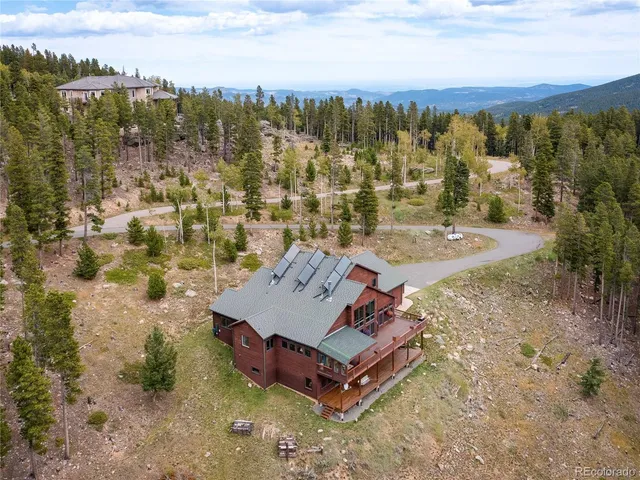 an aerial view of a house with a yard and lake view
