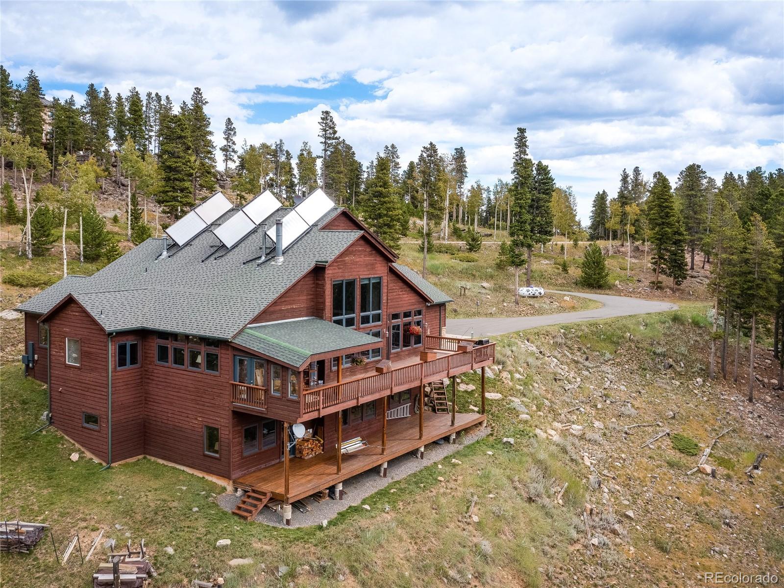 76 Raven Rdg Road Idaho Springs, CO 80452 - Photo 49 of 49 an aerial view of a house with a big yard and large trees