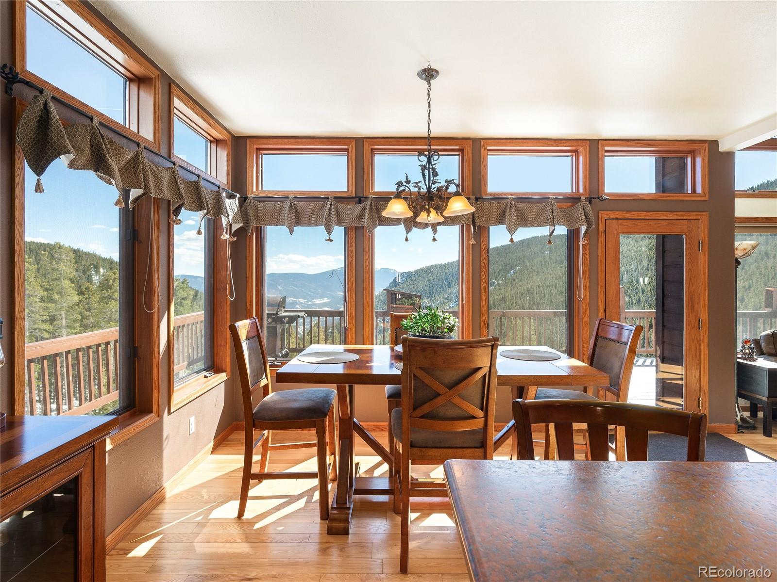 76 Raven Rdg Road Idaho Springs, CO 80452 - Photo 5 of 49 a dining room with furniture wooden floor a chandelier