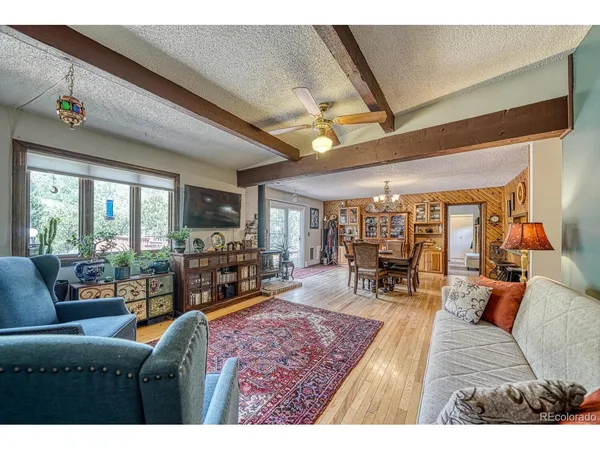 a living room with furniture large window and outer view