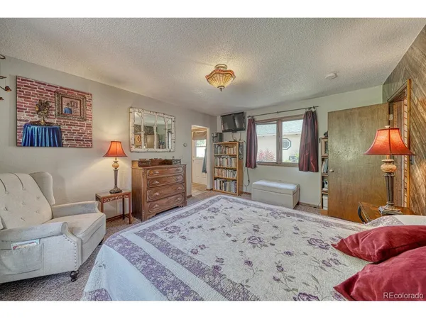 a bedroom with a large bed and a couch