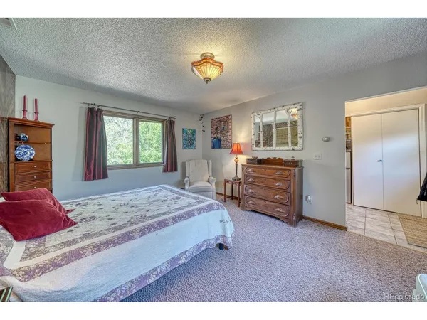a bedroom with a bed and a dresser in it
