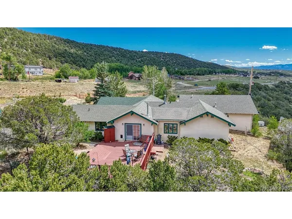 a aerial view of a house with a yard and lake view
