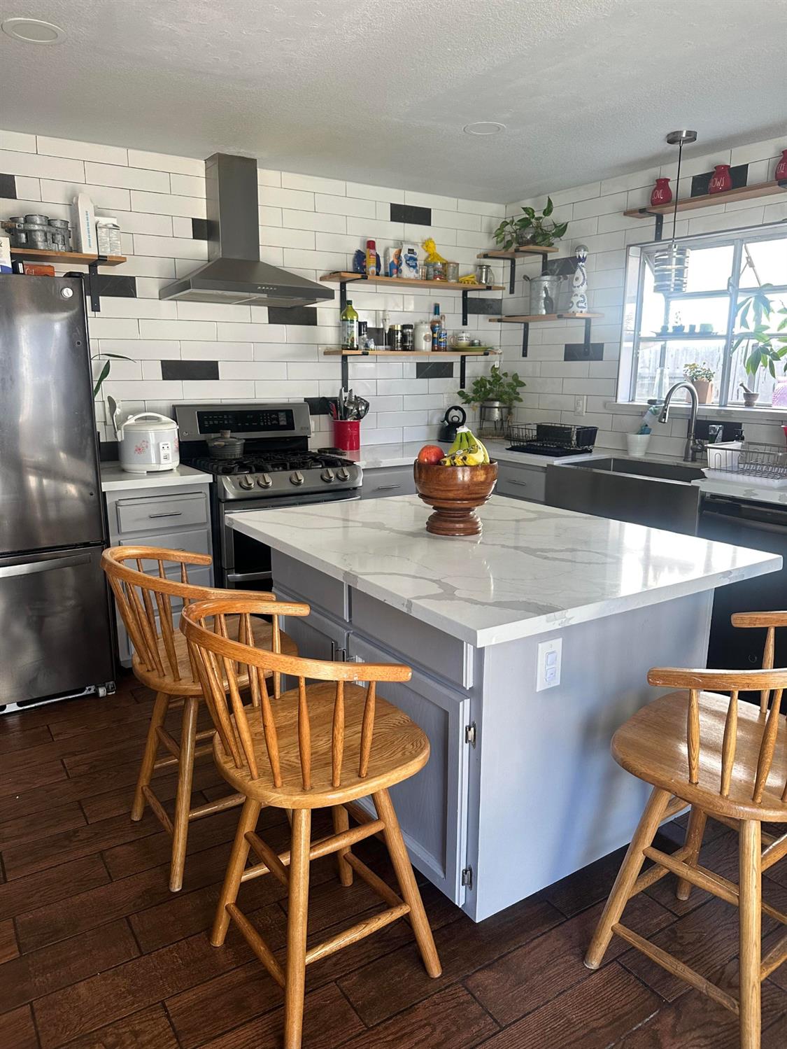 3608 Cassie Lane Ceres, CA 95307 - Photo 17 of 25 a kitchen with a table chairs and wooden floors