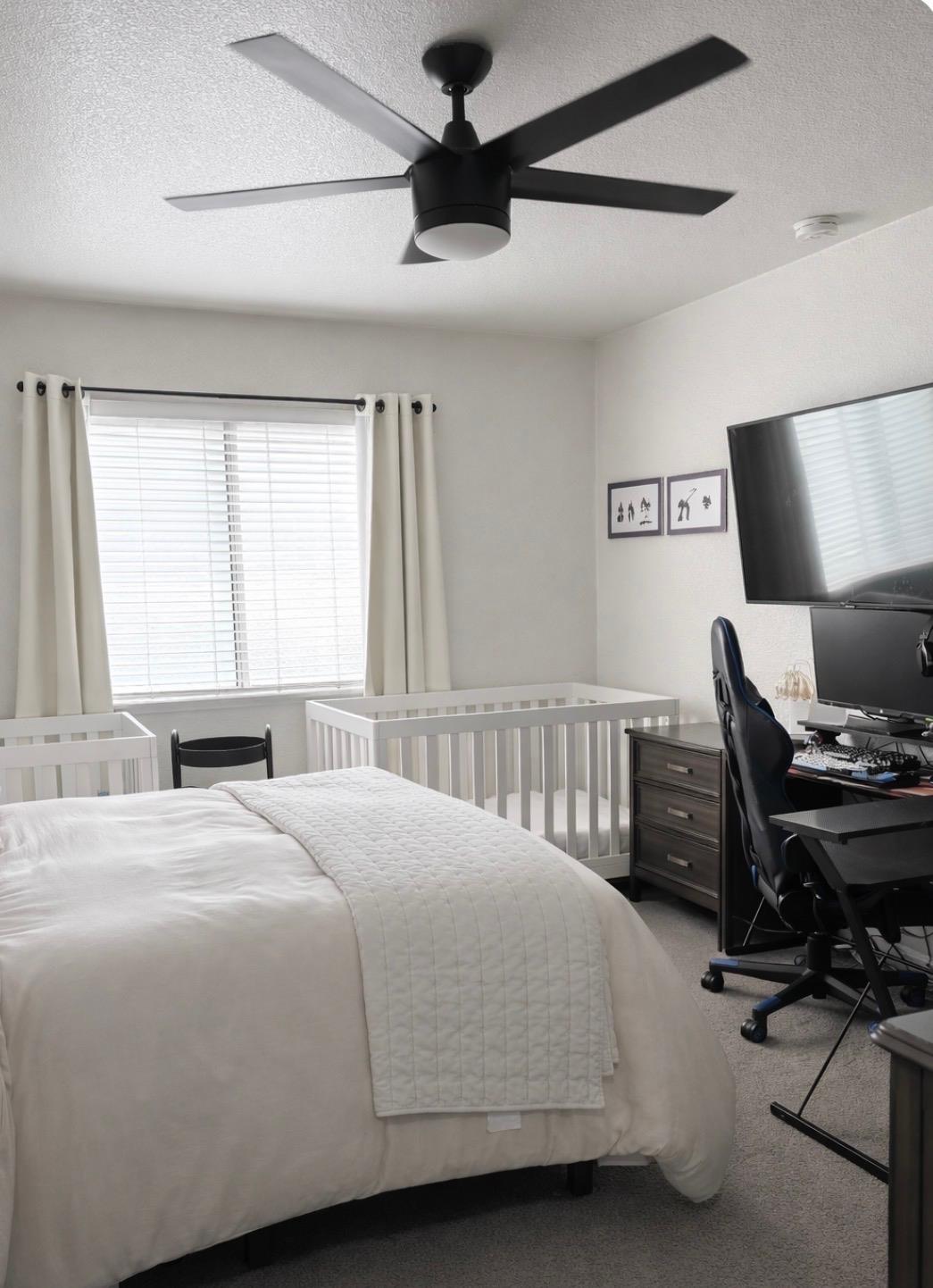 3608 Cassie Lane Ceres, CA 95307 - Photo 4 of 25 a bedroom with a bed and a computer on the desk