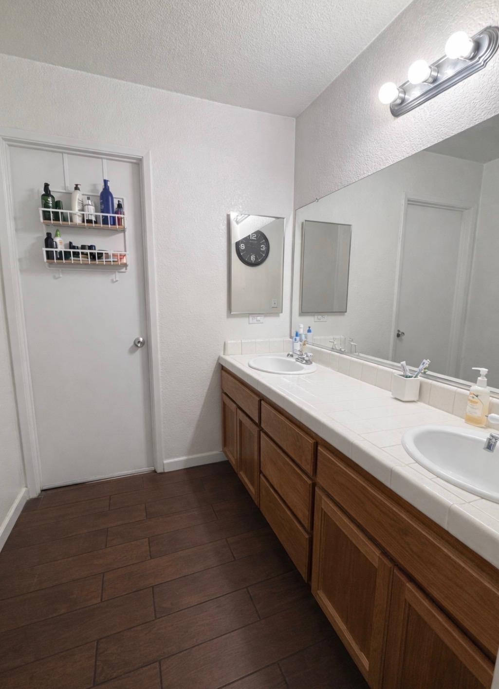 3608 Cassie Lane Ceres, CA 95307 - Photo 5 of 25 a spacious bathroom with a double vanity sink and a mirror