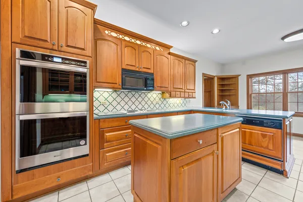 a kitchen with stainless steel appliances granite countertop a stove and a refrigerator
