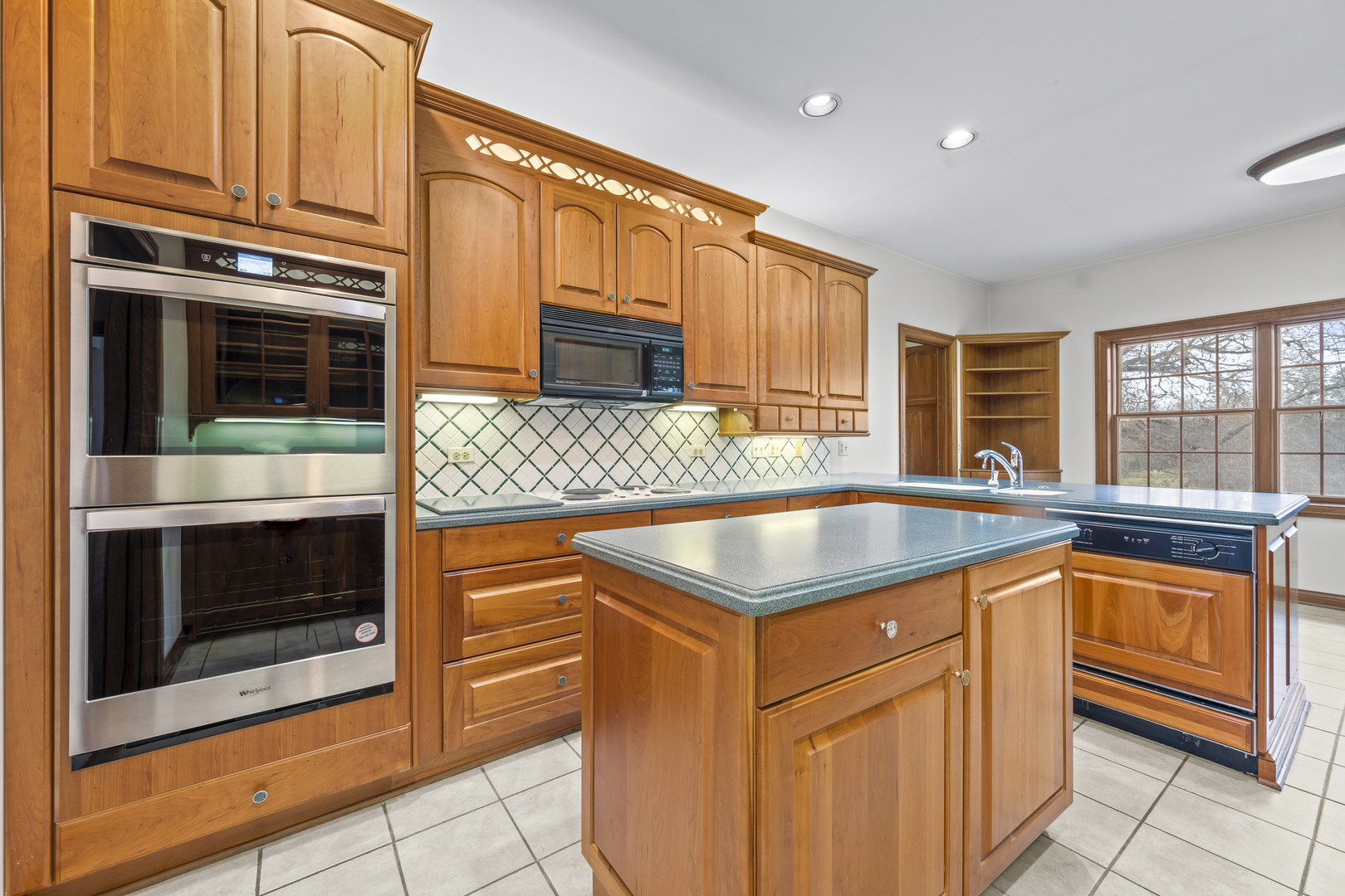 32981 North River Road Libertyville, IL 60048 - Photo 15 of 44 a kitchen with stainless steel appliances granite countertop a sink and a microwave