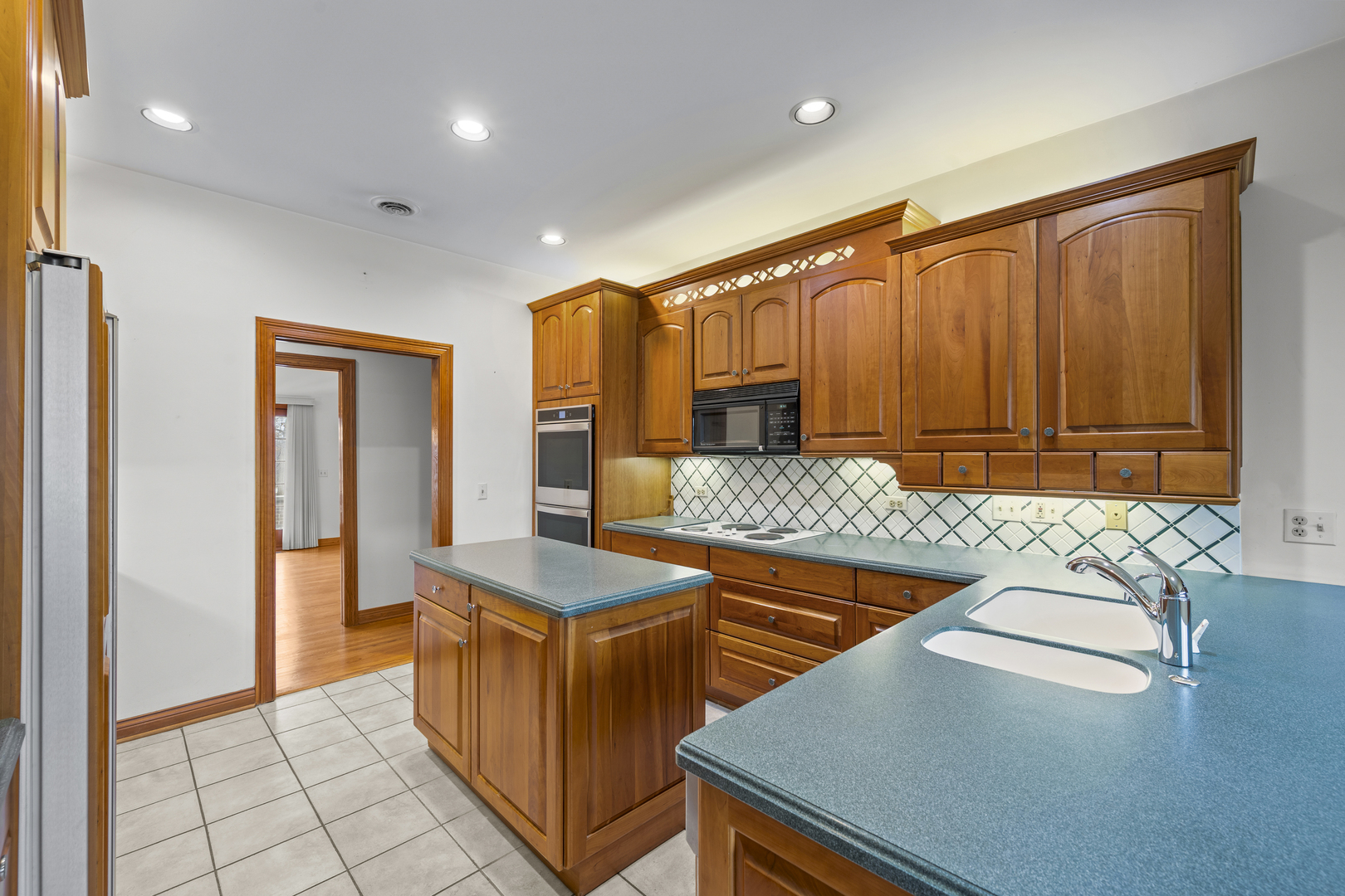 32981 North River Road Libertyville, IL 60048 - Photo 16 of 44 a kitchen with stainless steel appliances granite countertop a sink counter space and a refrigerator