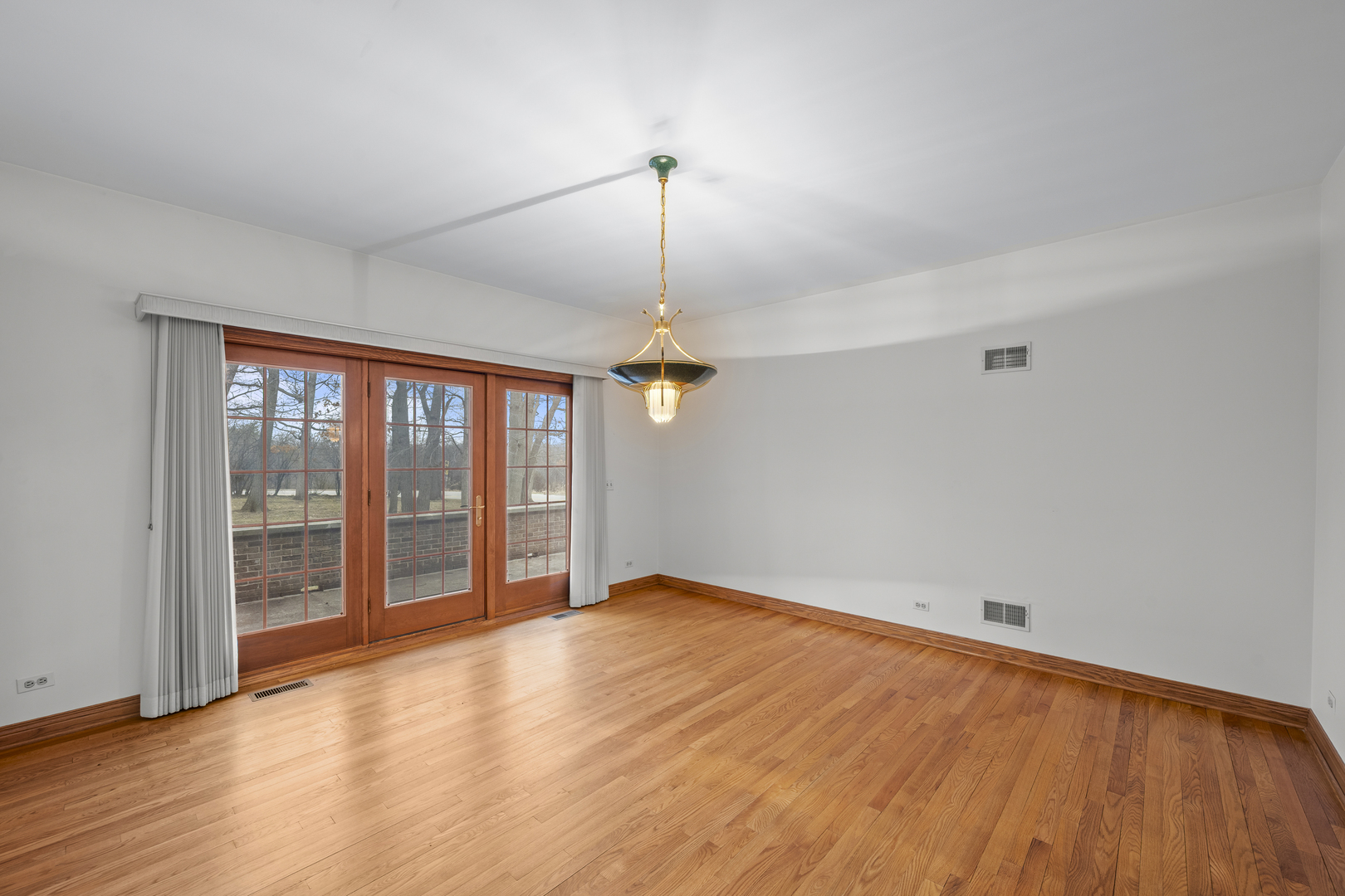 32981 North River Road Libertyville, IL 60048 - Photo 19 of 44 a view of an empty room with wooden floor and a window