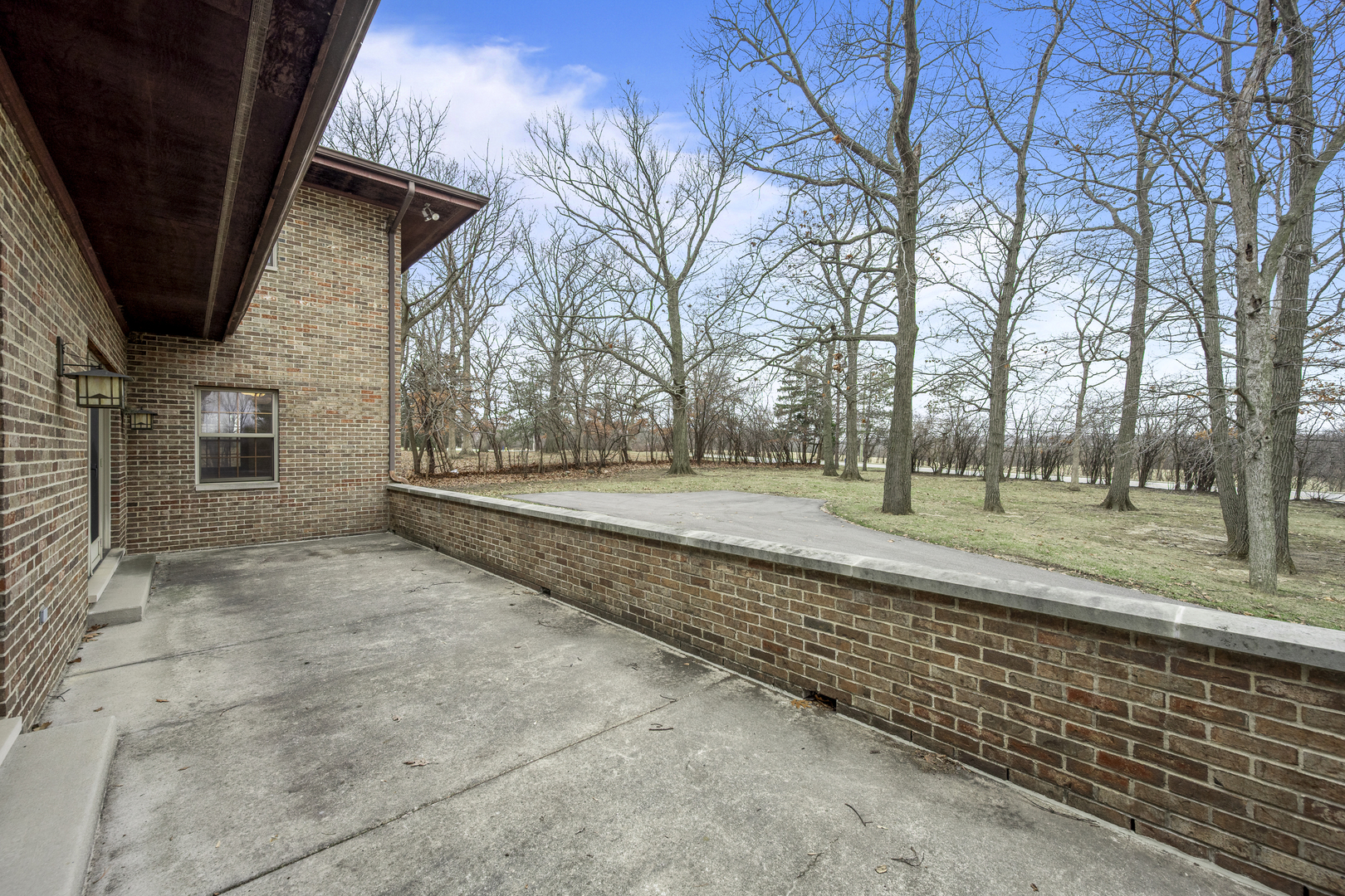 32981 North River Road Libertyville, IL 60048 - Photo 22 of 44 a view of a yard with brick wall