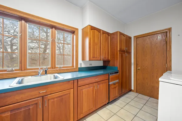a bathroom with a granite countertop sink toilet and a mirror